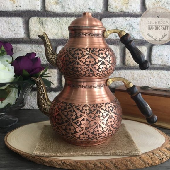 Traditional copper teapot with wooden handle